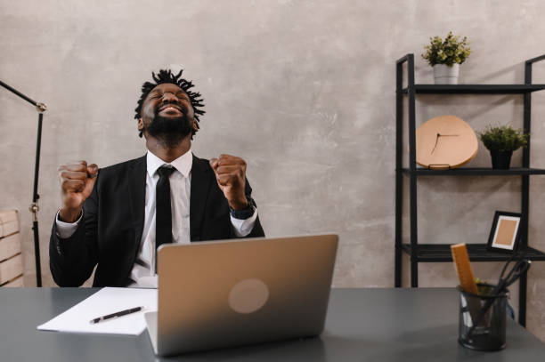 Black Businessman using laptop for analyzing data stock market, forex trading graph, stock exchange trading online, financial investment concept. close up.